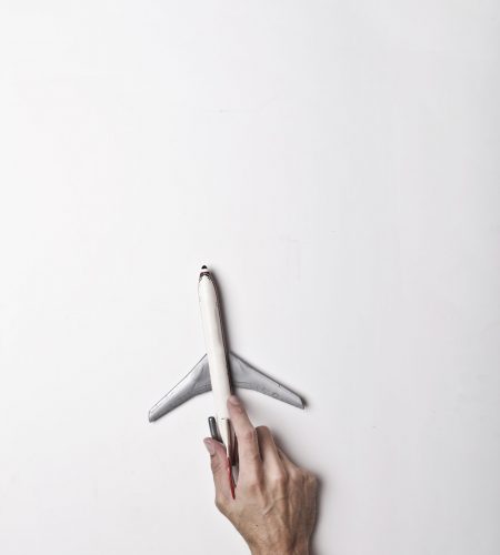 male-hand-with-white-toy-plane-3754680